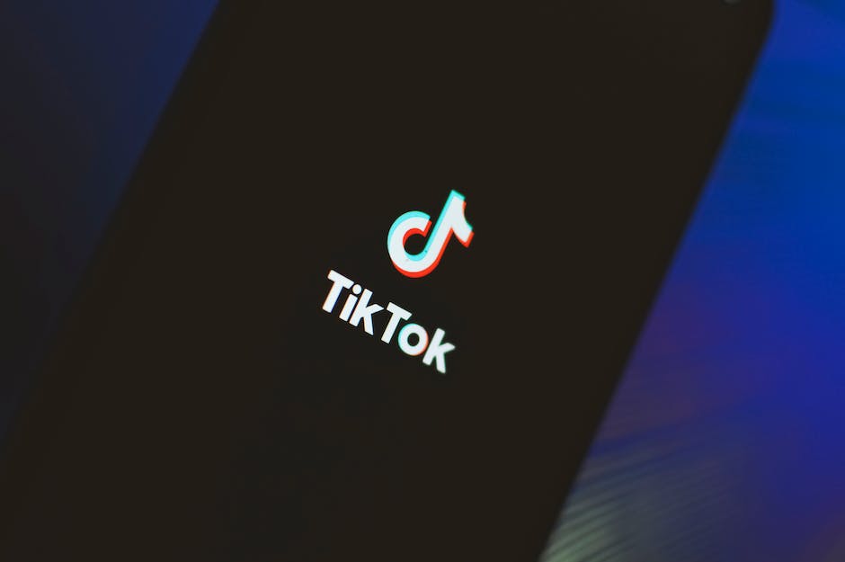 Image of a person holding a TikTok logo, representing TikTok music marketing.