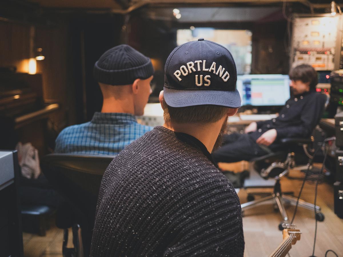 Image depicting people working collaboratively in a music studio